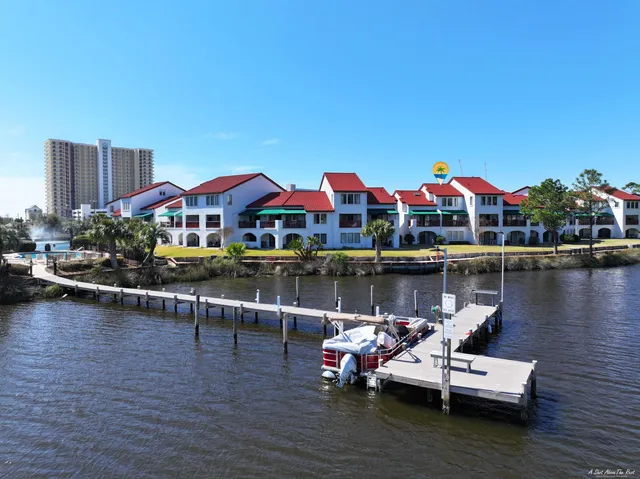 a view of a lake with lawn chairs