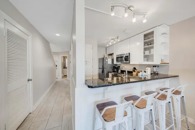 a kitchen with stainless steel appliances granite countertop a sink and cabinets