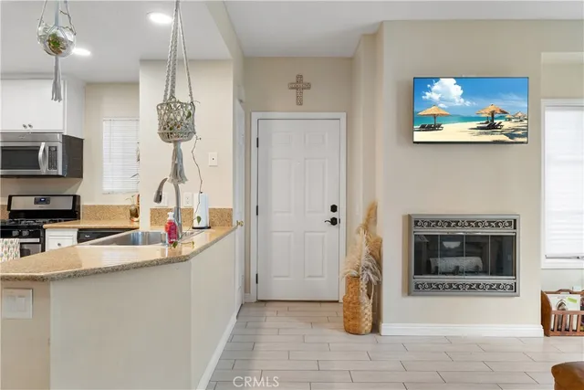 a kitchen with stainless steel appliances granite countertop a sink and a refrigerator