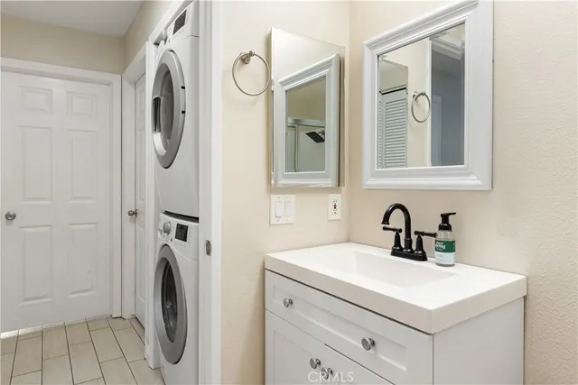 a large bed sitting in a bedroom next to a window