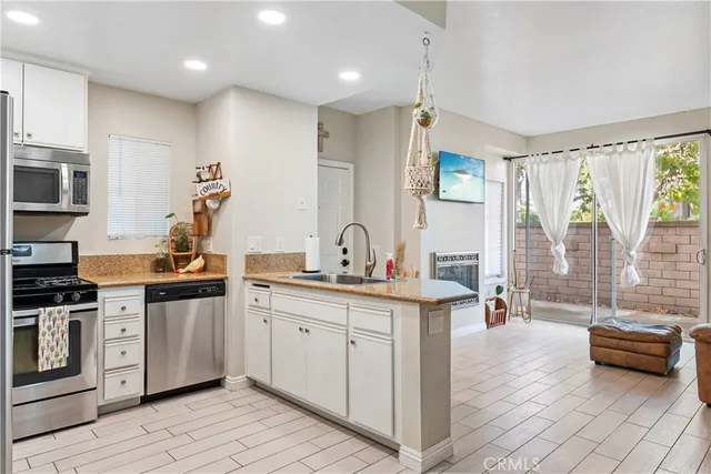 a kitchen with stainless steel appliances a sink stove and cabinets