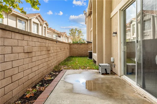a view of house with a yard and potted plants
