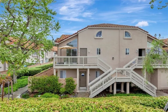 a view of residential houses with outdoor space and street view