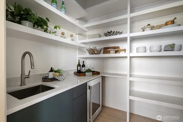 a kitchen with white cabinets and a sink