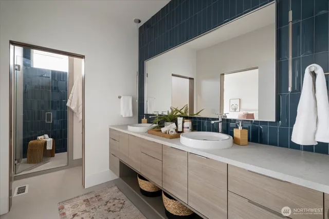 a bathroom with a double vanity sink and a mirror