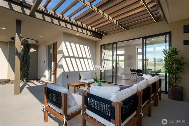 a living room with furniture a flat screen tv and a large window