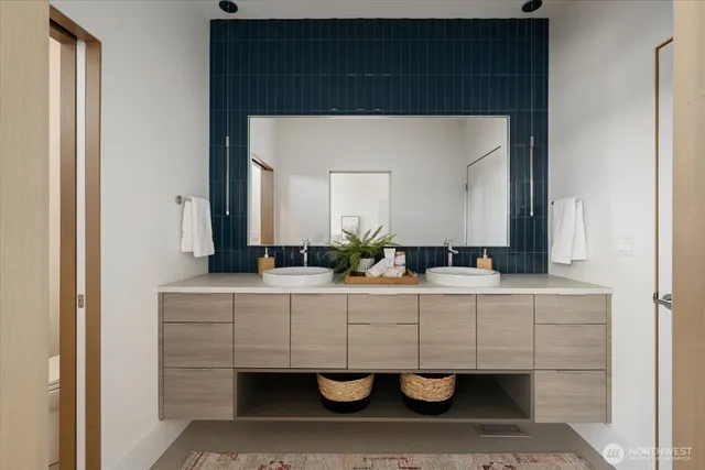 a bathroom with a sink a potted plant and a mirror