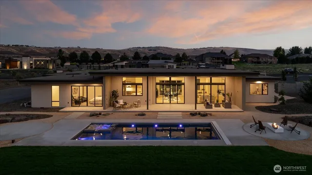a view of an chairs and table in a big yard