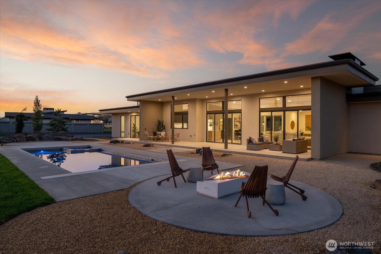 104118 East Addison Avenue Kennewick, WA 99338 - Photo 37 of 40 a view of a patio with couches table and chairs under an umbrella