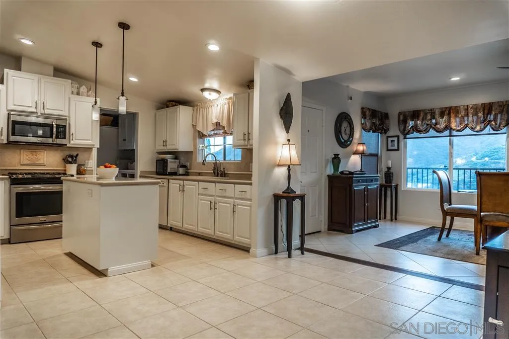 39325 De Luz Road Fallbrook, CA 92028 - Photo 12 of 25 a kitchen with stainless steel appliances a refrigerator sink and microwave