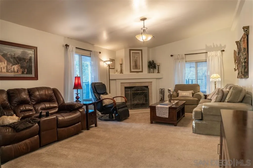 39325 De Luz Road Fallbrook, CA 92028 - Photo 17 of 25 a living room with furniture a fireplace and a chandelier