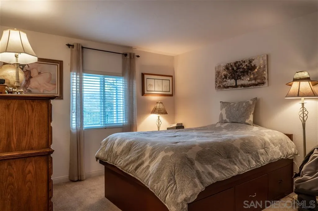39325 De Luz Road Fallbrook, CA 92028 - Photo 19 of 25 a bedroom with a bed and wooden floor