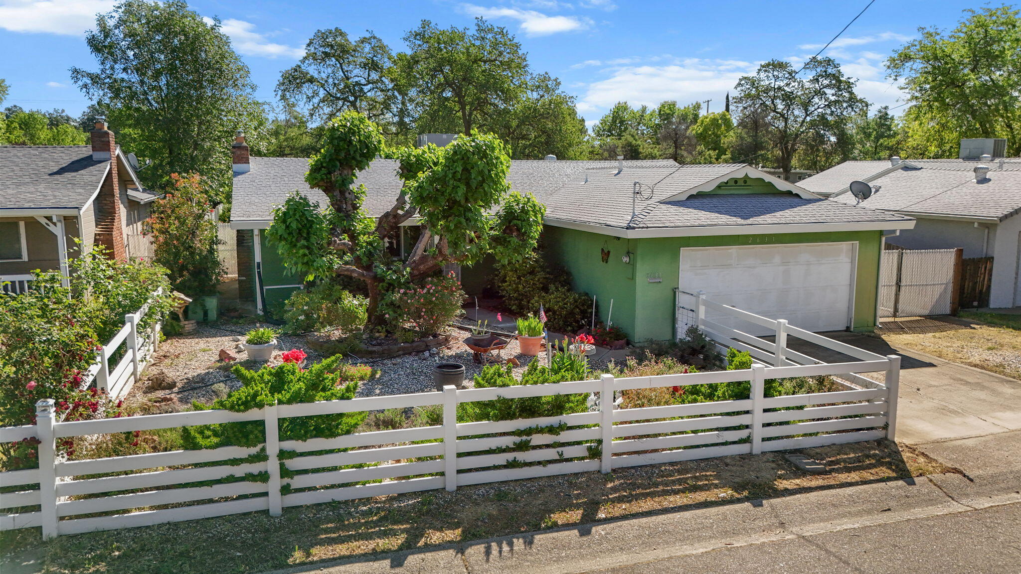 2631 Alfreda Way Redding, CA 96002 - Photo 1 of 16 a front view of a house with a garden