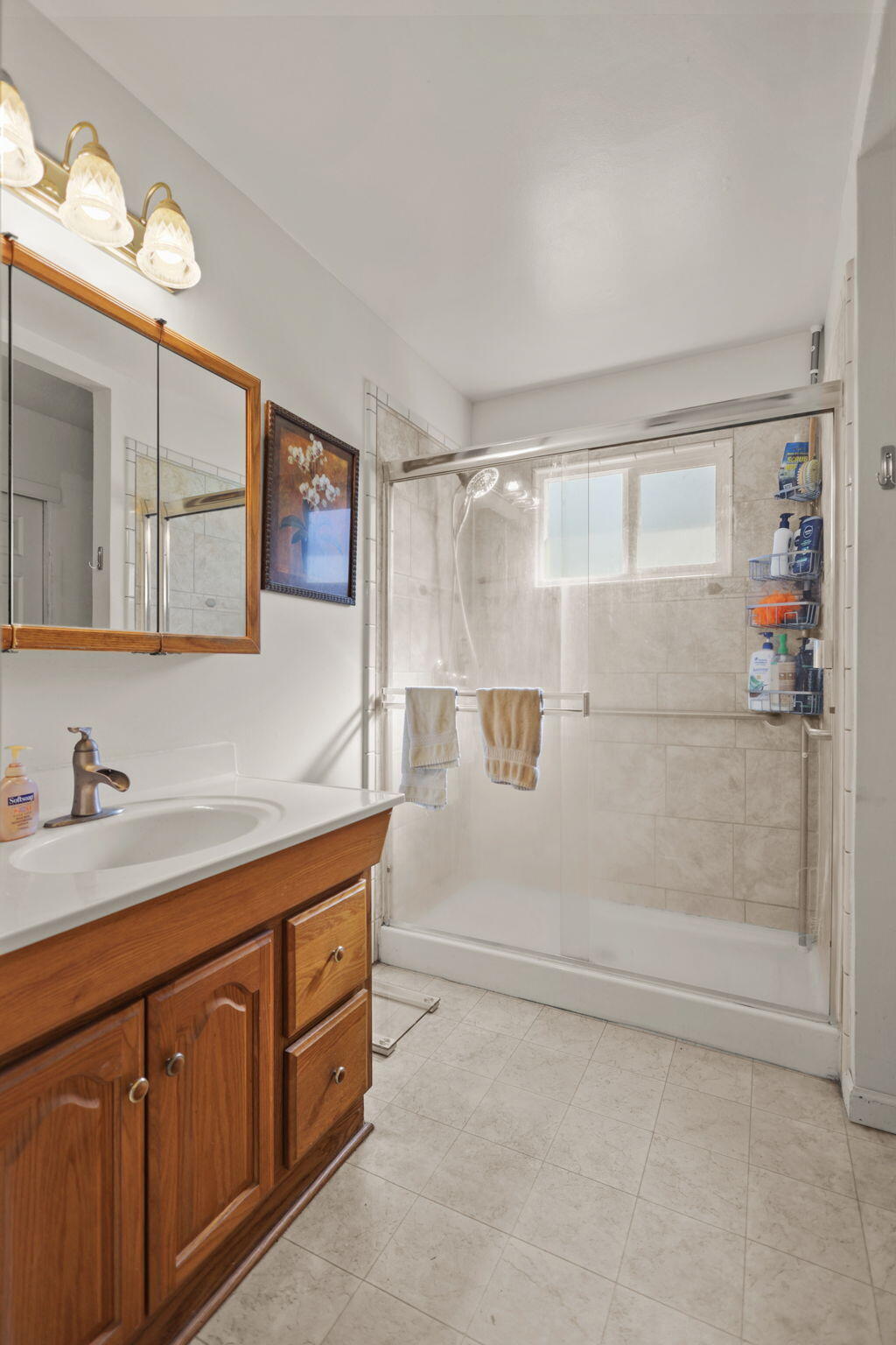 2631 Alfreda Way Redding, CA 96002 - Photo 8 of 16 a bathroom with a granite countertop sink a mirror and a shower