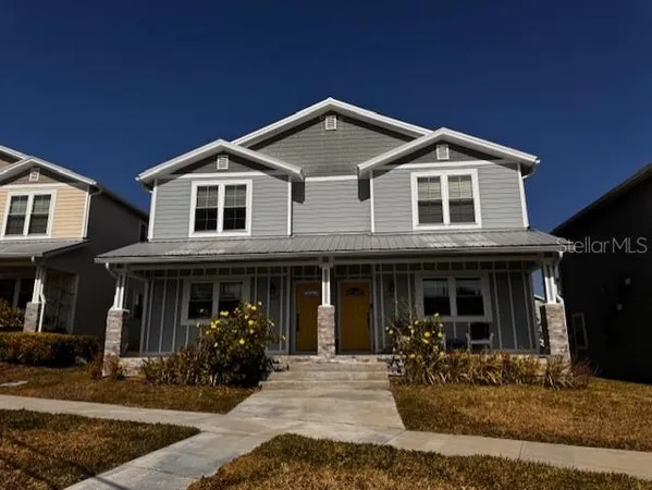 a front view of a house with yard and porch