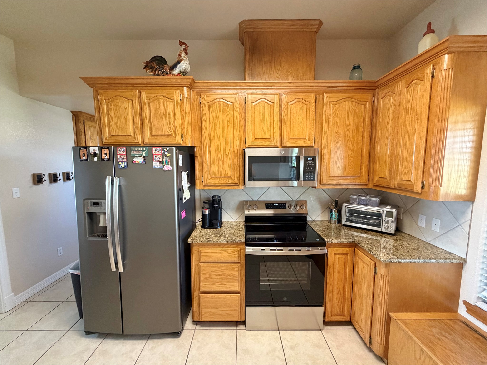 15903 County Road 621 Angleton, TX 77515 - Photo 12 of 33 a kitchen with stainless steel appliances granite countertop a refrigerator stove and microwave