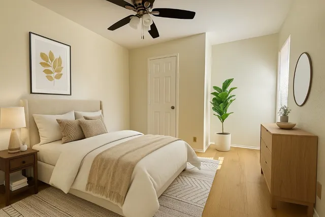 a bedroom with bed and a chandelier