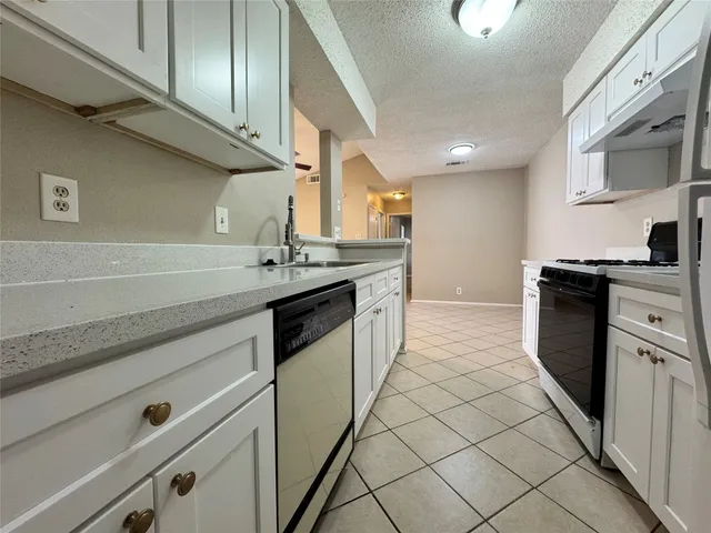 a kitchen with stainless steel appliances granite countertop a sink and a stove