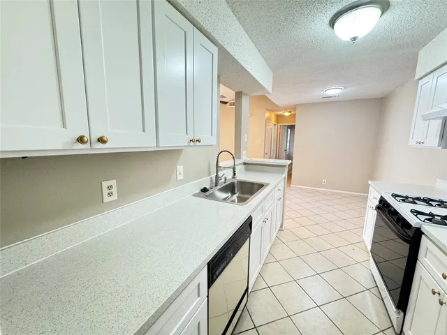 a kitchen with stainless steel appliances a stove a sink and a refrigerator