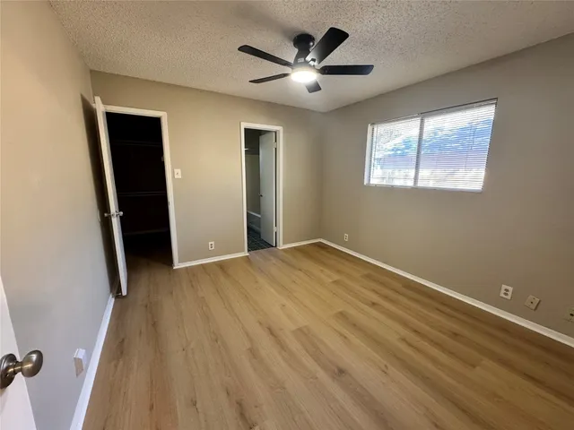 a view of empty room with wooden floor