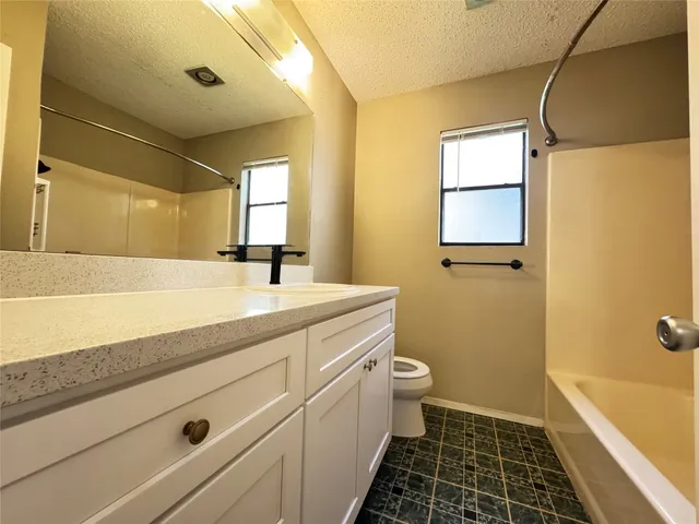 a bathroom with a sink a toilet a shower and a mirror