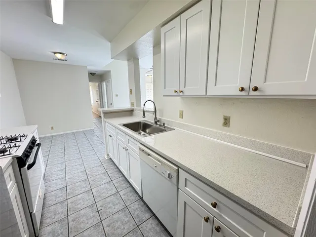 a kitchen with a sink and cabinets