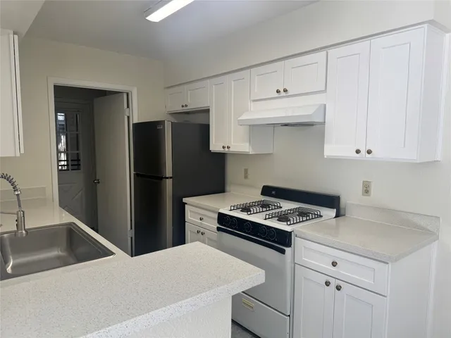 a kitchen with cabinets and stainless steel appliances