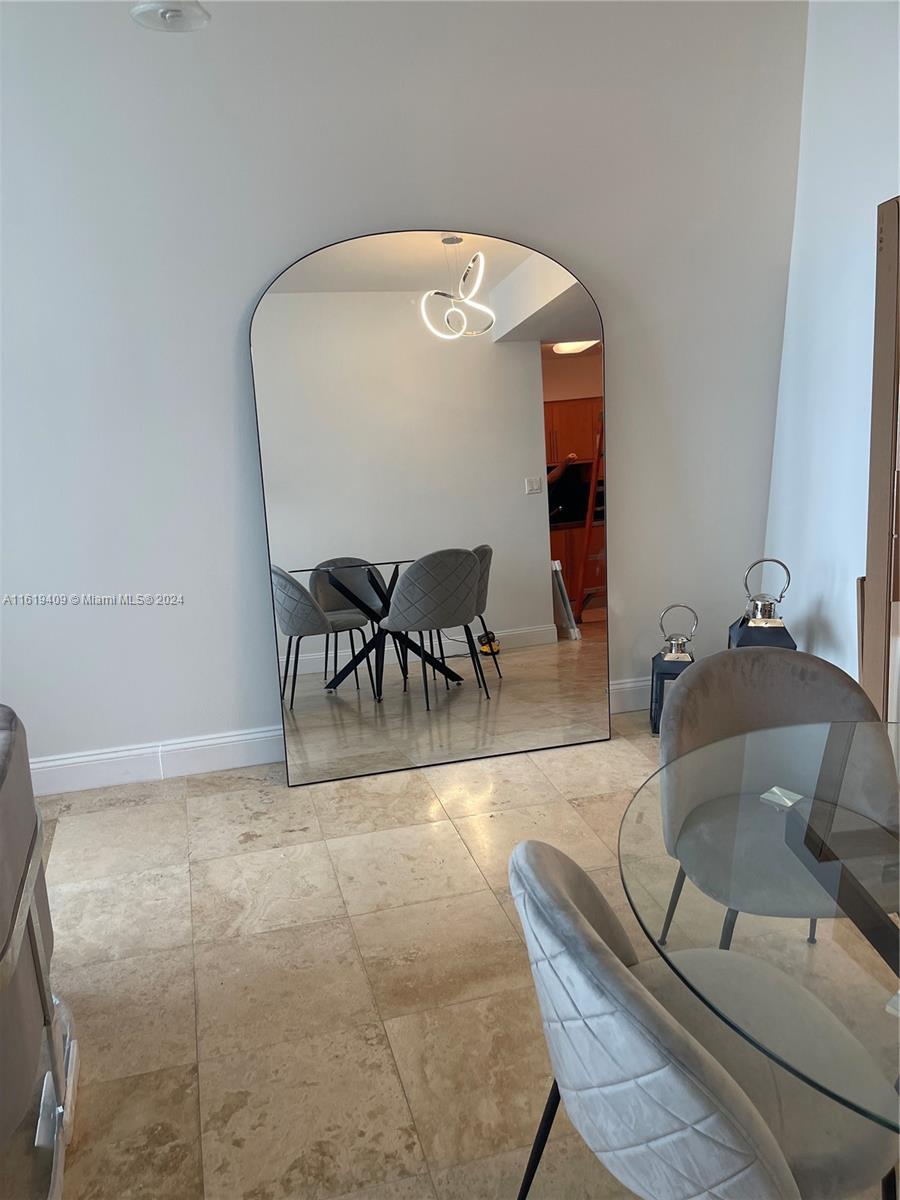 6365 Collins Avenue, Unit 2610 Miami Beach, FL 33141 - Photo 17 of 49 a view of a dining room with furniture and wooden floor