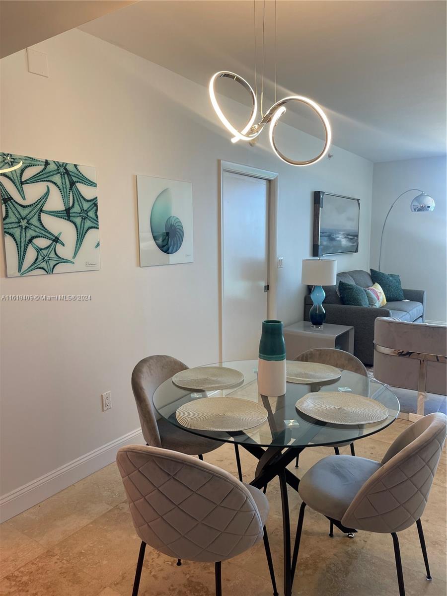6365 Collins Avenue, Unit 2610 Miami Beach, FL 33141 - Photo 19 of 49 a view of a dining room with furniture