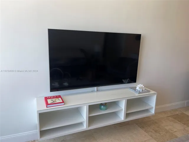 a view of room with window and a flat screen tv