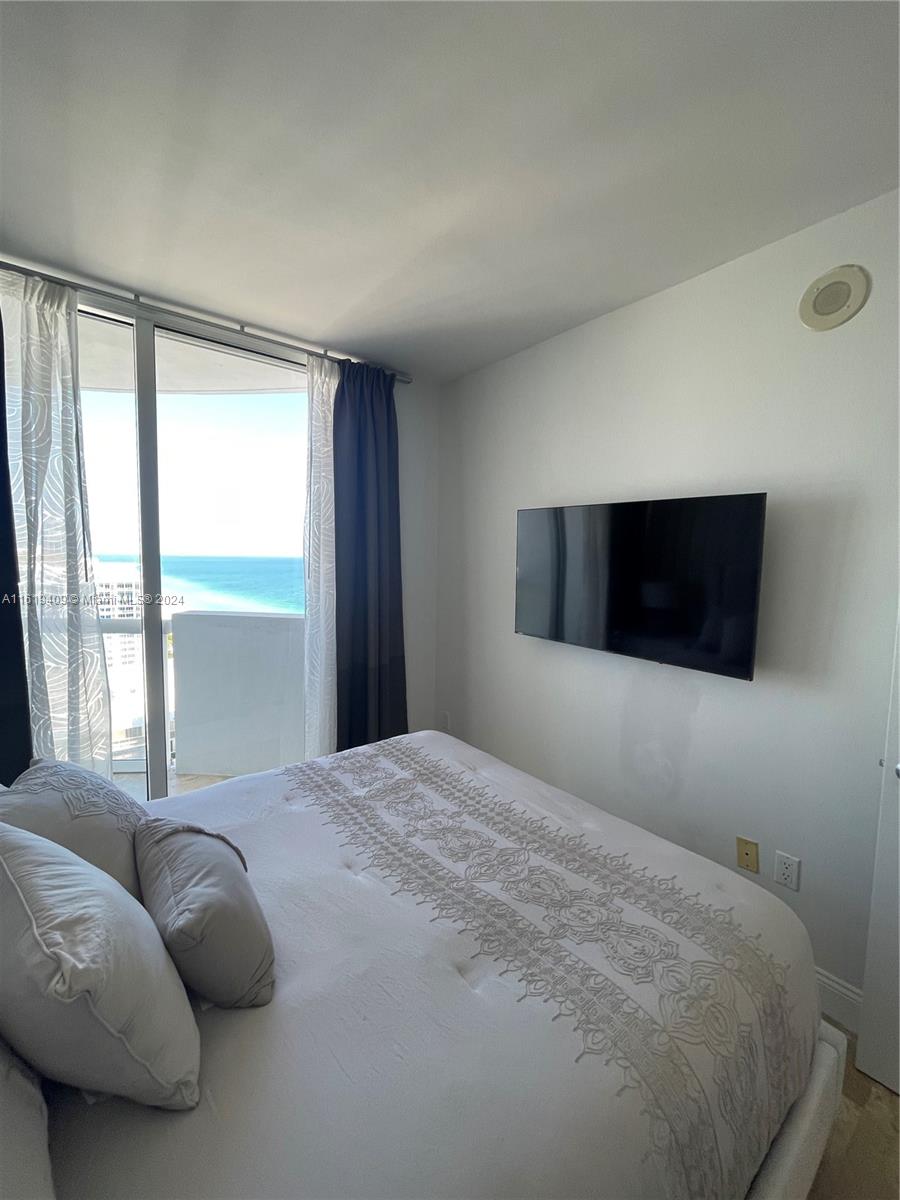 6365 Collins Avenue, Unit 2610 Miami Beach, FL 33141 - Photo 28 of 49 a bedroom with a bed and a large window