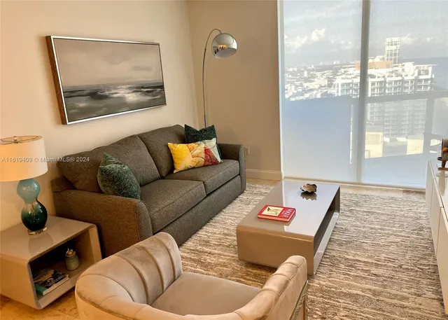 a view of a livingroom with furniture and a window