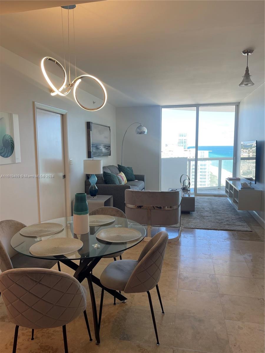 6365 Collins Avenue, Unit 2610 Miami Beach, FL 33141 - Photo 32 of 49 a view of a dining room with furniture