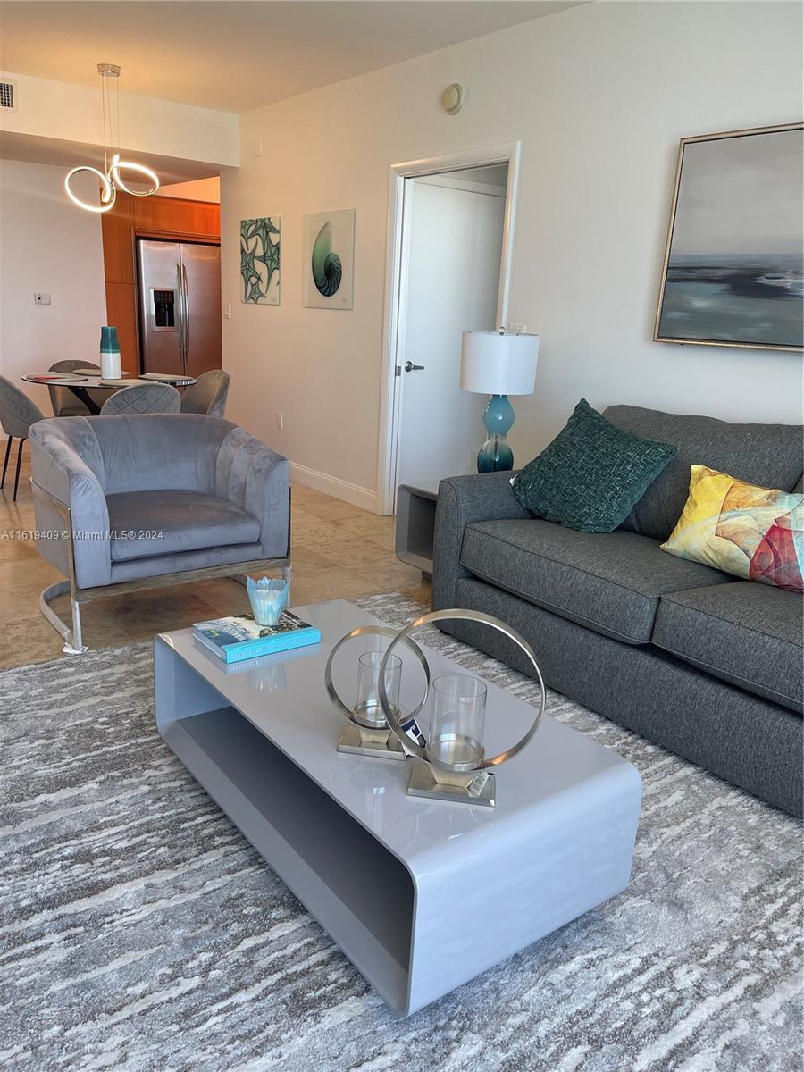 6365 Collins Avenue, Unit 2610 Miami Beach, FL 33141 - Photo 33 of 49 a living room with furniture and a wooden floor