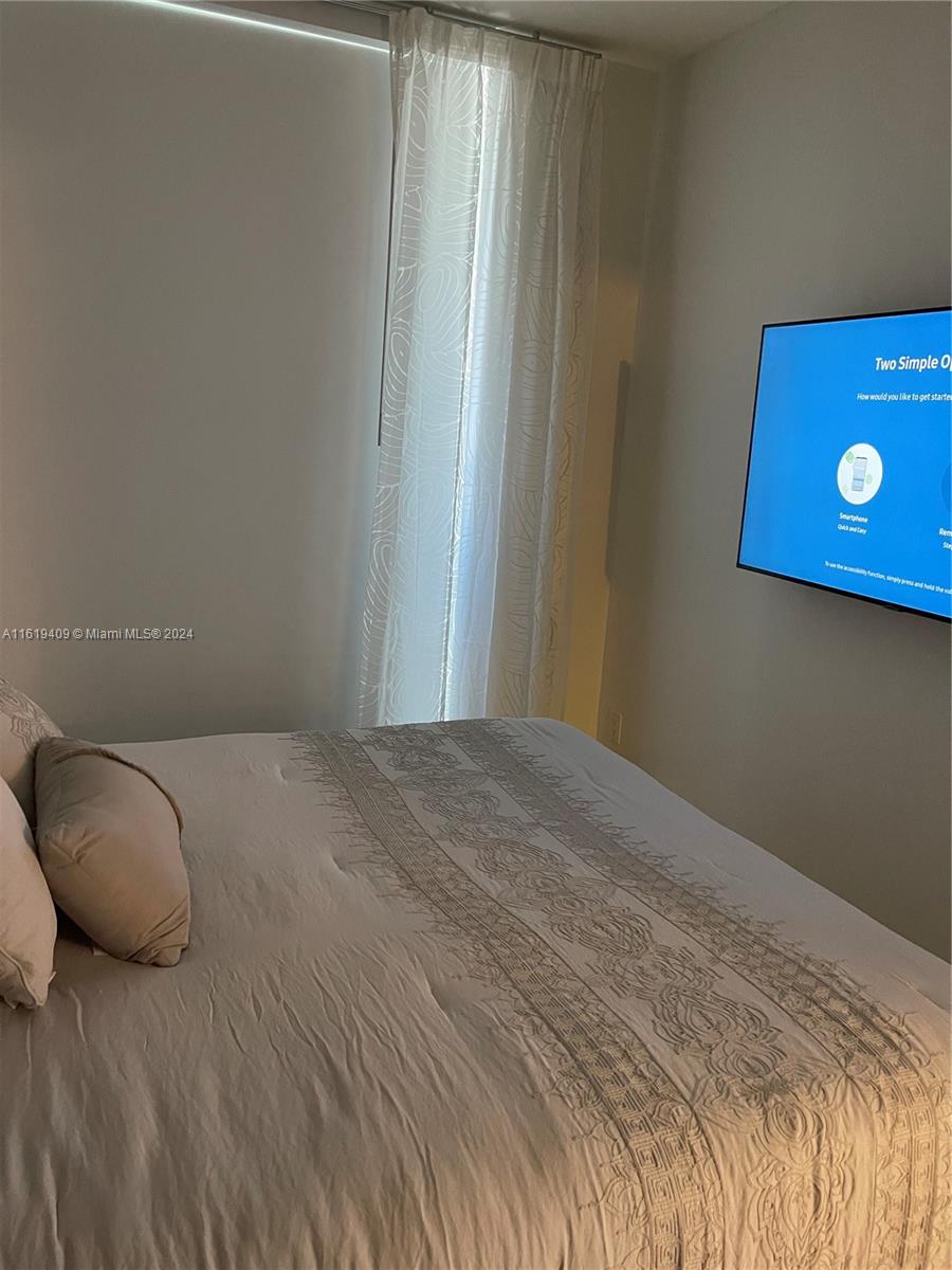 6365 Collins Avenue, Unit 2610 Miami Beach, FL 33141 - Photo 36 of 49 a bedroom with a bed and a couch