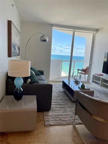 a bedroom with a bed and curtain