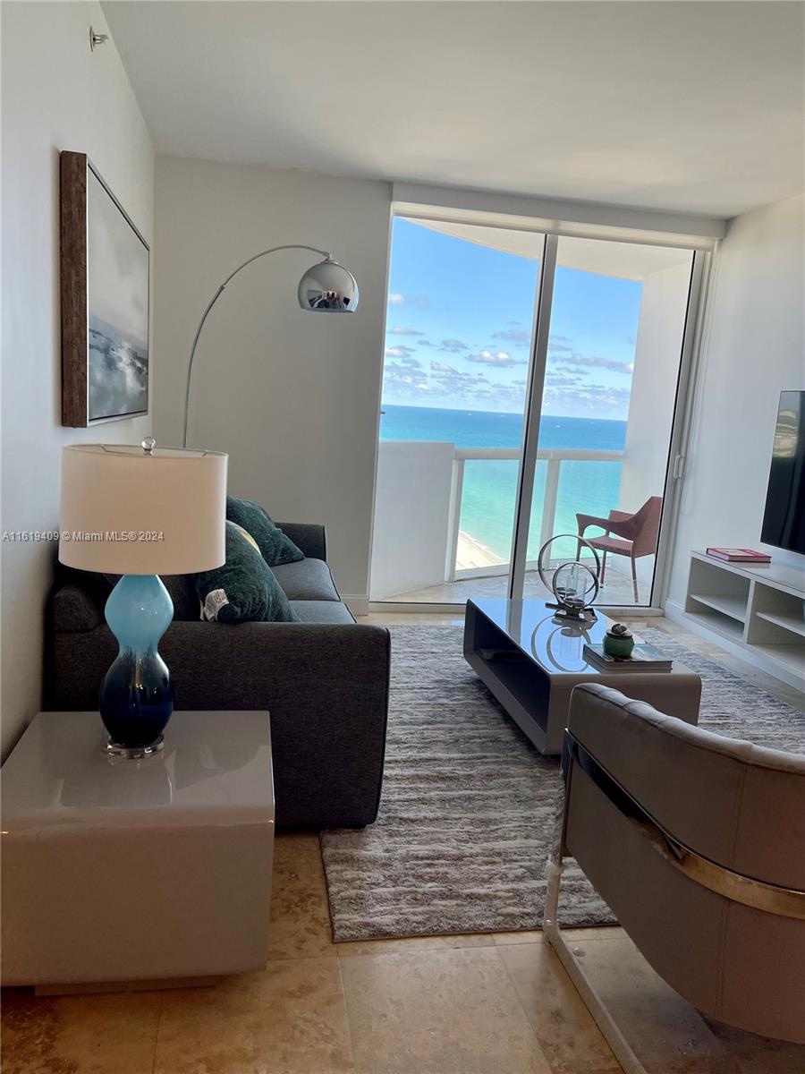 6365 Collins Avenue, Unit 2610 Miami Beach, FL 33141 - Photo 39 of 49 a living room with furniture and a large window