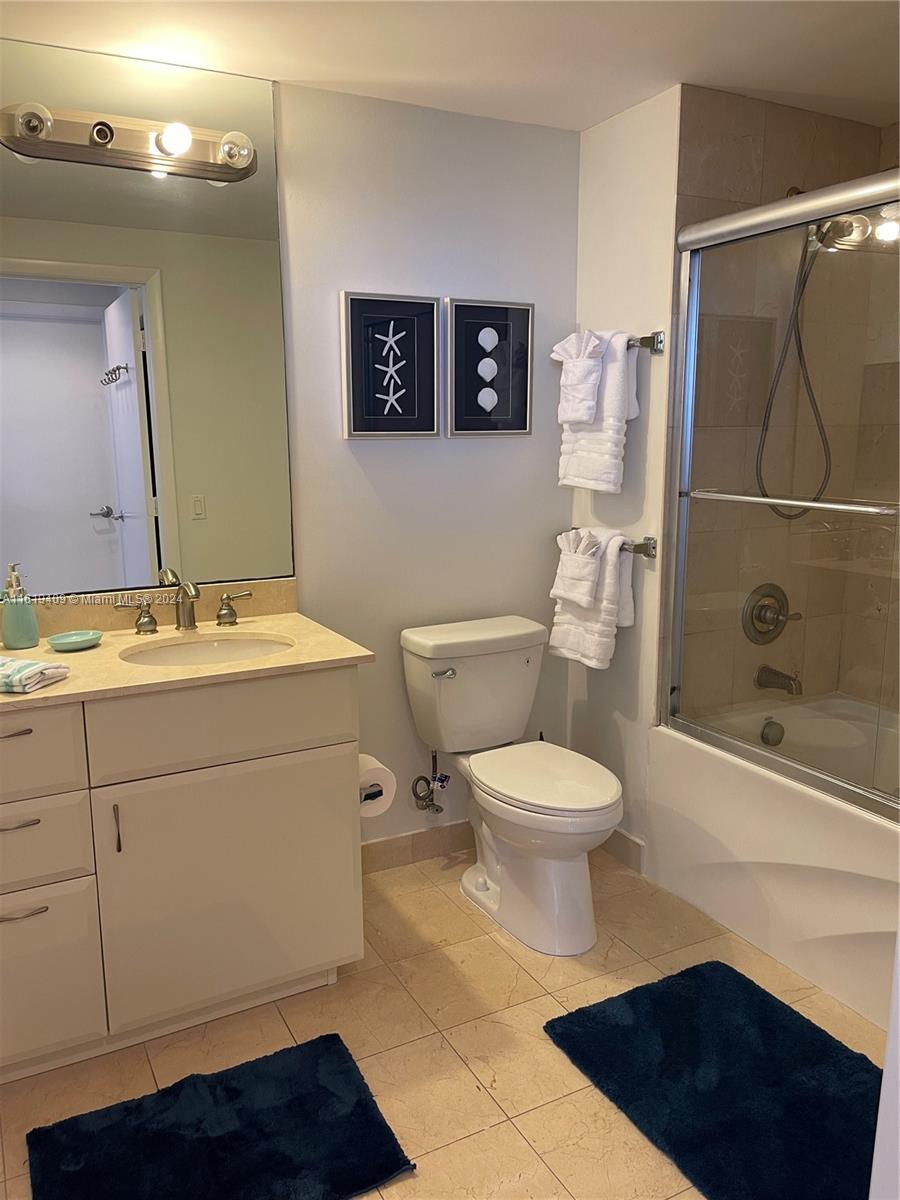 6365 Collins Avenue, Unit 2610 Miami Beach, FL 33141 - Photo 43 of 49 a bathroom with a toilet a sink and shower
