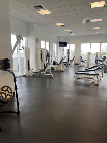 a room with gym equipment and a large window