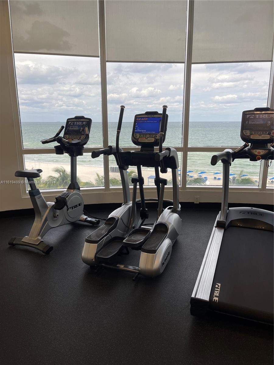 6365 Collins Avenue, Unit 2610 Miami Beach, FL 33141 - Photo 48 of 49 a room with gym equipment and a large window