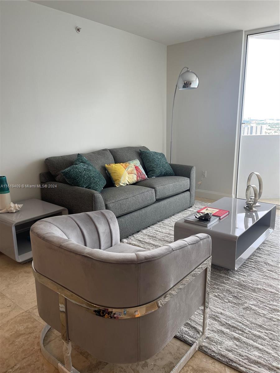 6365 Collins Avenue, Unit 2610 Miami Beach, FL 33141 - Photo 7 of 49 a living room with furniture and a window