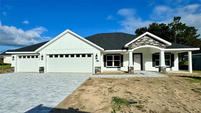 a front view of a house with a garden and pathway
