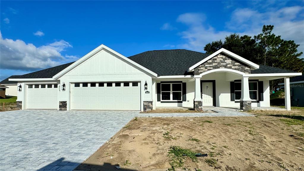 a front view of a house with a garden and pathway