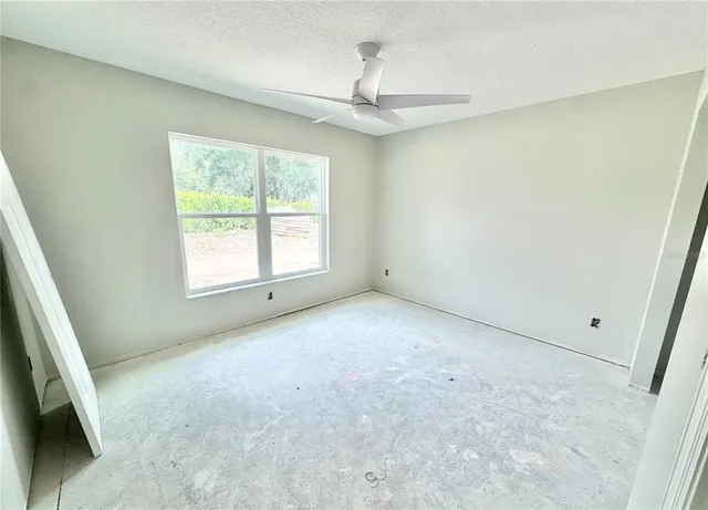 an empty room with mirror and a sink