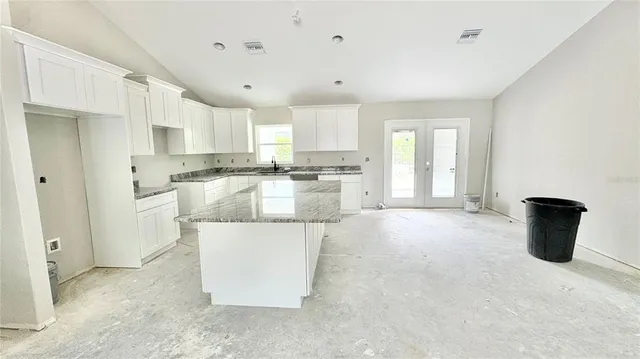 a kitchen with a stove a sink and a refrigerator