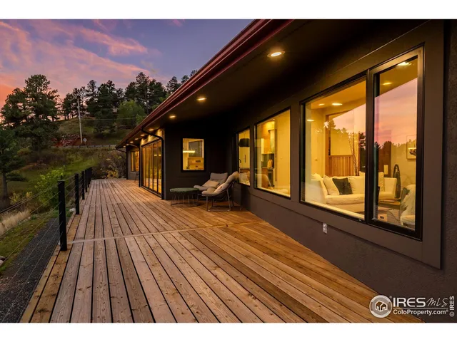a view of balcony with furniture and wooden floor