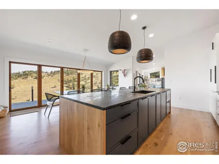 a kitchen with a table chairs and a view of living room
