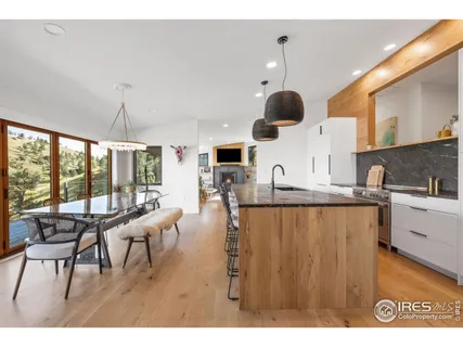 a living room with stainless steel appliances granite countertop furniture and a large window