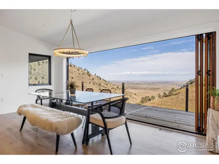 a living room with a table and a chandelier