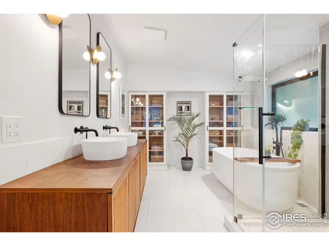 a spacious bathroom with a sink double vanity and a mirror